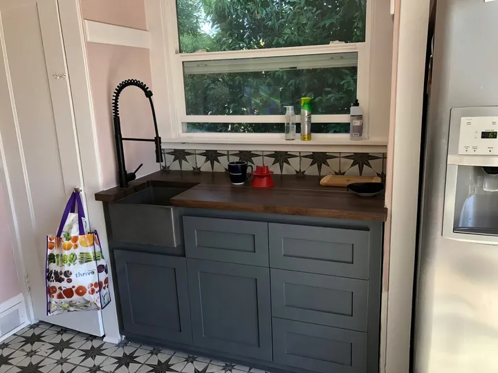 Kitchen after renovation with new cabinets, flooring, and paint
